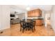 Cozy dining area open to living room with wood floors and cabinet with granite countertop at 17309 Knoxwood Dr, Huntersville, NC 28078