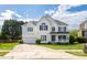 Inviting two-story home with a manicured lawn, attached garage, and a charming front porch at 17309 Knoxwood Dr, Huntersville, NC 28078