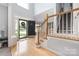 Bright foyer with hardwood floors, staircase, and a view of the home's entry at 17309 Knoxwood Dr, Huntersville, NC 28078