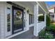 Charming front porch view with the address displayed, lovely wreath, and classic design at 17309 Knoxwood Dr, Huntersville, NC 28078