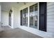 Inviting front porch showcasing the home's windows, shutters, and covered entryway at 17309 Knoxwood Dr, Huntersville, NC 28078