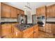 Well-equipped kitchen with stainless steel appliances, island cooktop, and ample cabinetry at 17309 Knoxwood Dr, Huntersville, NC 28078