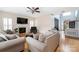 Bright living room with fireplace, ceiling fan, neutral walls, and comfortable furnishings at 17309 Knoxwood Dr, Huntersville, NC 28078