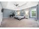 Spacious main bedroom suite with tray ceiling, desk, and ensuite bathroom at 17309 Knoxwood Dr, Huntersville, NC 28078