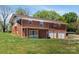 Brick home featuring a spacious backyard with lush green grass and a detached two-car garage at 175 Neita Dr, Salisbury, NC 28147