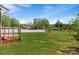 A spacious green backyard with a patio cover, partial fence, and beautiful trees at 175 Neita Dr, Salisbury, NC 28147