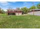 Large grassy backyard featuring mature trees, a privacy fence, and a two car garage at 175 Neita Dr, Salisbury, NC 28147