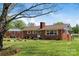 Lovely brick home with well-manicured lawn and mature trees providing a serene backdrop at 175 Neita Dr, Salisbury, NC 28147