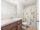 Bathroom featuring wood cabinets and a shower/tub combo with patterned curtains at 1957 Beth Haven Church Rd, Denver, NC 28037