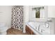 Bright bathroom featuring a soaking tub, a window, and a toilet at 1957 Beth Haven Church Rd, Denver, NC 28037