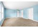 Spacious bedroom featuring soft carpet and multiple doors for easy access at 1957 Beth Haven Church Rd, Denver, NC 28037
