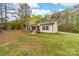 An exterior view of a single story home with a porch and shutters on a large lot at 1957 Beth Haven Church Rd, Denver, NC 28037