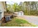Exterior view of a detached two car garage with a gravel driveway surrounded by trees at 1957 Beth Haven Church Rd, Denver, NC 28037