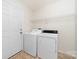 A laundry room with a white washer and dryer, a door and a wire shelf at 1957 Beth Haven Church Rd, Denver, NC 28037