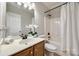 Bright bathroom featuring a single sink vanity, and a tub-shower combination at 2004 Ptarmigan Ct, Waxhaw, NC 28173