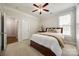 Comfortable bedroom with a ceiling fan, a queen-sized bed, neutral tones, and ample natural light at 2004 Ptarmigan Ct, Waxhaw, NC 28173