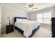 Charming bedroom features a well-made bed and a matching black nightstand, well lit by the large window at 2004 Ptarmigan Ct, Waxhaw, NC 28173