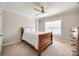 Comfortable bedroom featuring a wooden bed frame and a ceiling fan with overhead lighting at 2004 Ptarmigan Ct, Waxhaw, NC 28173