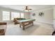 Spacious bonus room features a pool table, comfortable seating, and large windows with natural light at 2004 Ptarmigan Ct, Waxhaw, NC 28173