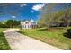 Beautiful home with a long driveway, stone accents, black shutters, a front porch, and a lush green lawn at 2004 Ptarmigan Ct, Waxhaw, NC 28173
