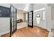 Welcoming foyer showcasing hardwood floors, a bright entry door, and elegant French doors leading to a versatile space at 2004 Ptarmigan Ct, Waxhaw, NC 28173