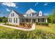 Charming two-story home showcasing a stone facade, manicured landscaping, and inviting front porch with dark shutters at 2004 Ptarmigan Ct, Waxhaw, NC 28173
