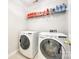Laundry room with modern washer and dryer and storage shelf, providing convenience at 2004 Ptarmigan Ct, Waxhaw, NC 28173