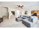 Comfortable living room featuring plush seating, a ceiling fan, and an open floor plan leading to the kitchen at 2004 Ptarmigan Ct, Waxhaw, NC 28173