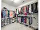 Large walk-in closet with ample hanging space and storage bins, keeping clothes organized at 2004 Ptarmigan Ct, Waxhaw, NC 28173
