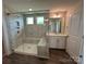 Modern bathroom featuring a large glass shower with marble patterned walls, and a white vanity at 2017 Embassy Ct # 51, Charlotte, NC 28213