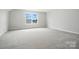Spacious bedroom with a large window offering natural light and serene views for comfortable living at 2017 Embassy Ct # 51, Charlotte, NC 28213
