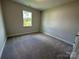 This carpeted bedroom is bright with a view from the window at 2017 Embassy Ct # 51, Charlotte, NC 28213
