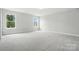 This bedroom features two windows, carpet flooring, and is brightly painted neutral paint at 2017 Embassy Ct # 51, Charlotte, NC 28213