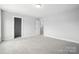 A carpeted bedroom with white walls and ensuite bathroom and walk-in closet entrances at 2017 Embassy Ct # 51, Charlotte, NC 28213