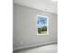 This bedroom features a large window offering outdoor views, carpet flooring, and neutral paint at 2017 Embassy Ct # 51, Charlotte, NC 28213