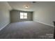 Upstairs bonus room with carpet, neutral paint, large window, and ceiling light at 2017 Embassy Ct # 51, Charlotte, NC 28213