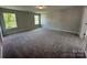 Bonus room featuring two windows and neutral carpeting at 2017 Embassy Ct # 51, Charlotte, NC 28213