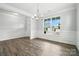 Dining room with natural light, wood floors, and wainscotting at 2017 Embassy Ct # 51, Charlotte, NC 28213