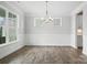 This dining room features crown moulding, wainscotting, wood floors, and a modern chandelier at 2017 Embassy Ct # 51, Charlotte, NC 28213