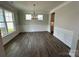 An elegant dining room featuring wood floors, decorative molding, and a stylish chandelier at 2017 Embassy Ct # 51, Charlotte, NC 28213