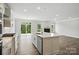 Kitchen with island open to the living room with fireplace and backyard access at 2017 Embassy Ct # 51, Charlotte, NC 28213