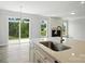 Kitchen with large island and view of the back patio with fireplace at 2017 Embassy Ct # 51, Charlotte, NC 28213