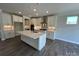 Modern kitchen features white cabinets, a marble backsplash, stainless steel appliances, and an island at 2017 Embassy Ct # 51, Charlotte, NC 28213