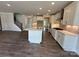 Bright kitchen featuring a central island, white cabinets, and stainless steel appliances, open to the living space at 2017 Embassy Ct # 51, Charlotte, NC 28213