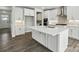 Modern kitchen featuring an island, stainless steel appliances, and stone countertops at 2017 Embassy Ct # 51, Charlotte, NC 28213