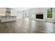 Spacious living room featuring hardwood floors, modern fireplace, and bright windows at 2017 Embassy Ct # 51, Charlotte, NC 28213