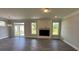 Spacious living room with wood floors, a fireplace with shiplap accents, and natural light at 2017 Embassy Ct # 51, Charlotte, NC 28213