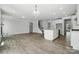 Open living room, adjacent to the kitchen, stairs, and garage entry at 2017 Embassy Ct # 51, Charlotte, NC 28213