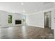 Spacious living room featuring hardwood floors, modern fireplace, and bright windows at 2017 Embassy Ct # 51, Charlotte, NC 28213