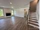 Open living area with a shiplap fireplace, a staircase, and ample natural light at 2017 Embassy Ct # 51, Charlotte, NC 28213